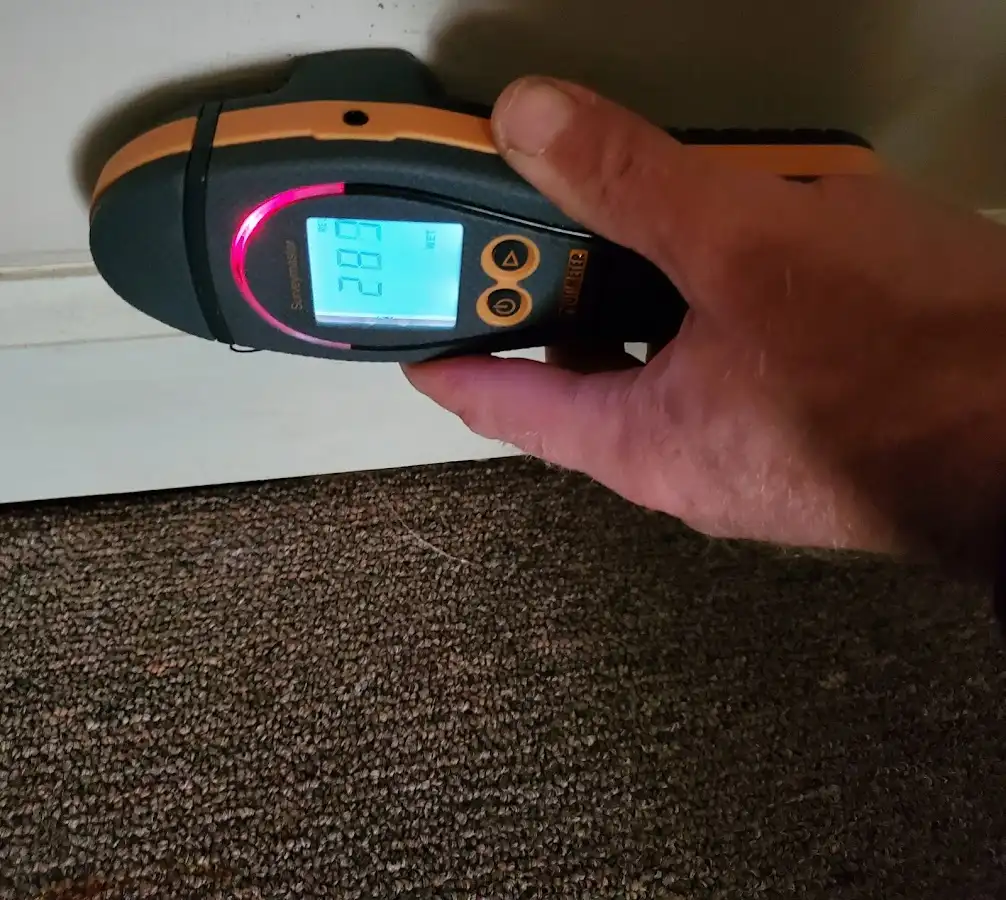 Moisture detection at baseboard during Storm Damage Restoration in Redmond